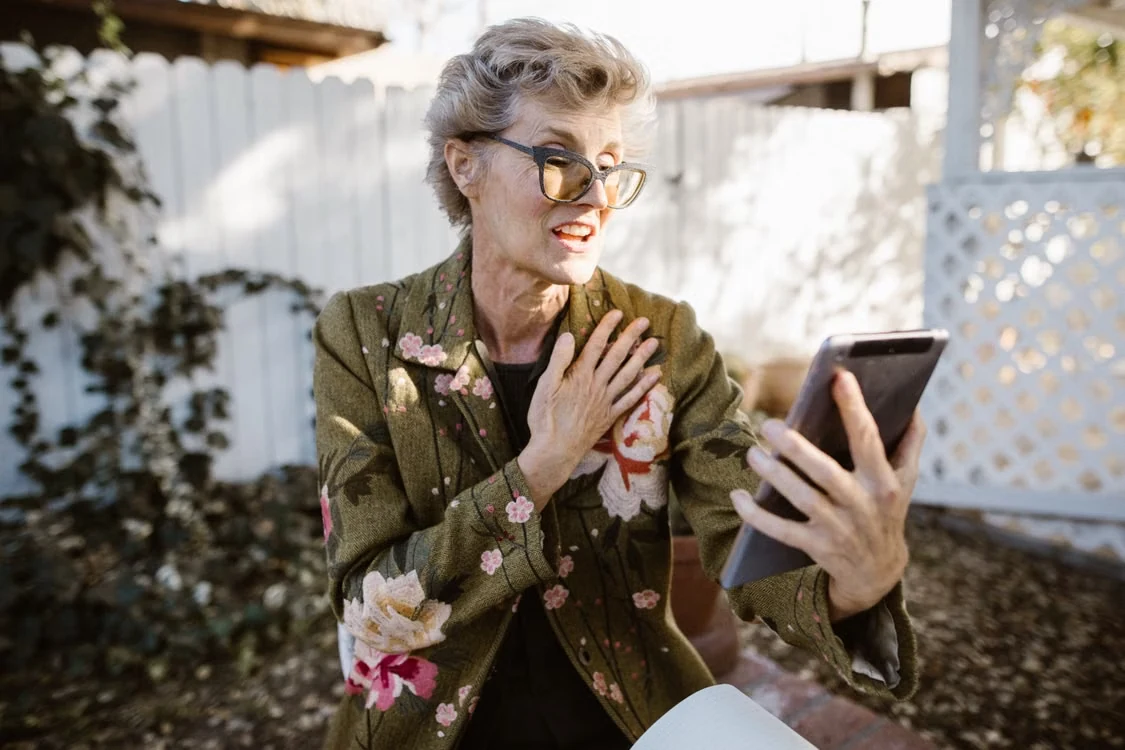 Senior woman having a relaxed phone conversation outdoors