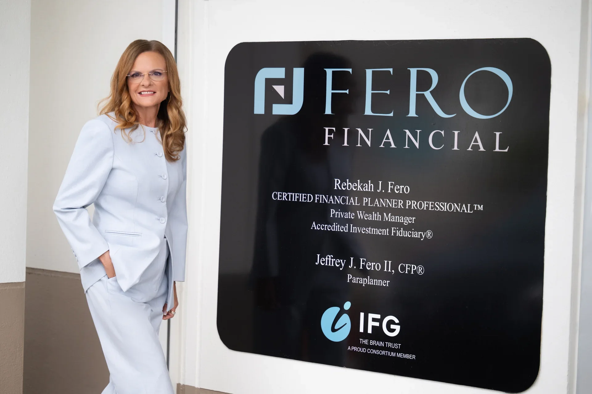Becky Fero in front of Fero Financial sign.