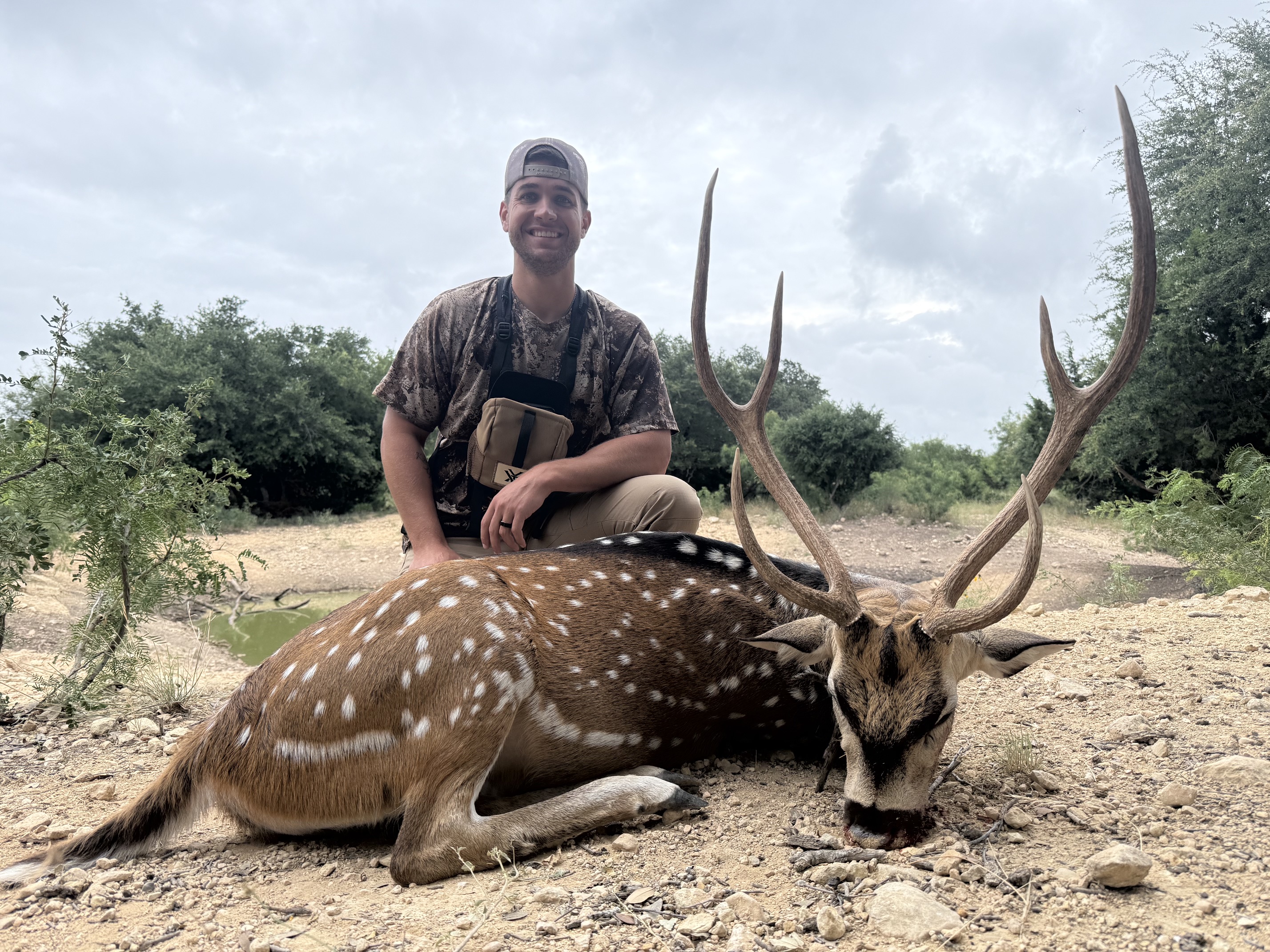 Axis hunter with a mature buck at FF Hunting Ranch in 2026