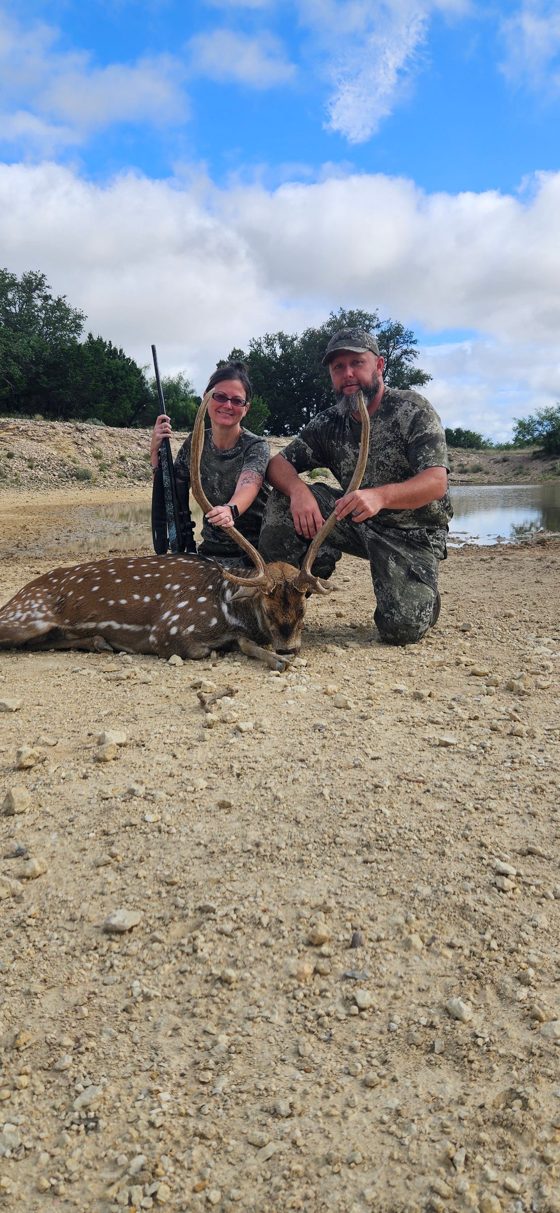 Two hunters with a harvested axis buck at FF Hunting Ranch in June 2026